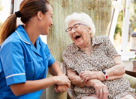 Senior,Woman,Sitting,In,Chair,And,Talking,With,Nurse,In